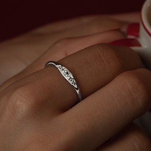 Silver-tone ring with engraved floral birth flower design band