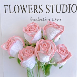 Crochet rose bouquet with pink roses, white accents, and green stems