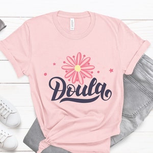 Pink t-shirt with 'Doula' script and flower graphic