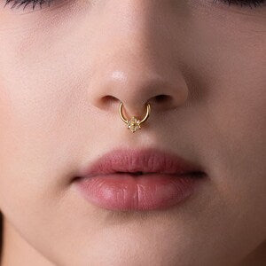 Gold septum clicker hoop ring with tiny flower charm in hinged closure