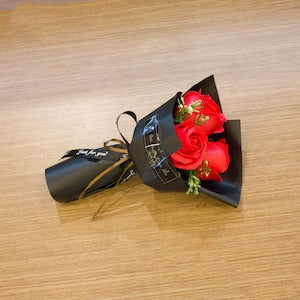 Mini rose bouquet gift with red rose and black wrap bow