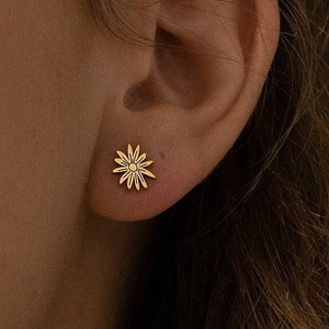 Birth flower stud earrings, gold-tone small floral design on ear
