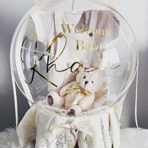 Personalized bubble bouquet basket with 'Welcome Baby' balloon, plush teddy and ribbon bow