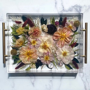 Clear acrylic resin tray with preserved multicolor flowers arranged inside