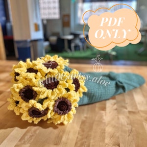 Crocheted sunflower bouquet applique on teal afghan blanket