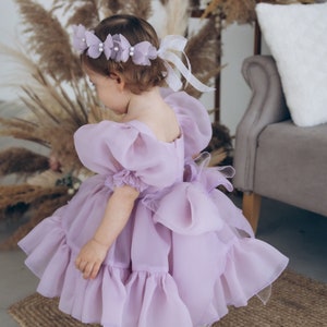 Pale lilac baby girl dress with layered organza tutu skirt and ruffled puff sleeves