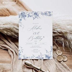 Dusty blue floral birthday invitation card with script name and RSVP details