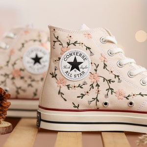 Custom embroidered high-top sneakers, white canvas with black floral vine around toe