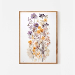 Framed pastel dried flower wall art with purple and orange pressed blooms and stems