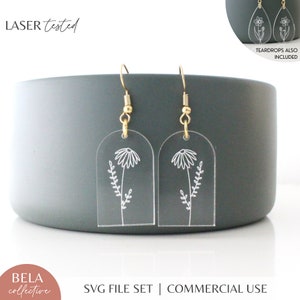 Gold-tone arch drop earrings with etched flower-and-leaf dangles, hanging stud style