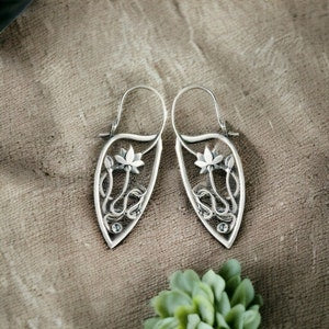Silver flower dangle earrings with filigree leaf design and drop hooks