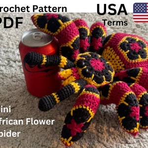 Colorful crochet spider plush toy with pink, yellow, and black legs