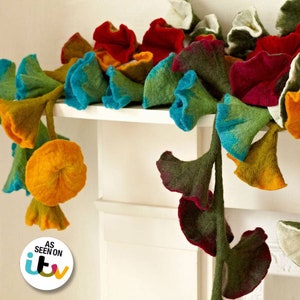 Handcrafted felt flower garland with multicolor flowers, draped across the mantle