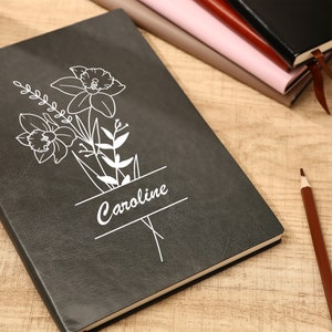 Black birth-flower journal with floral line art and custom name Caroline
