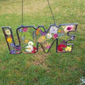 Hanging pressed flower letter frame with stained-glass style floral art, multicolor