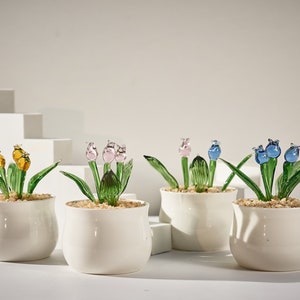 Handmade glass potted succulents with stained-glass flower accents in white pots