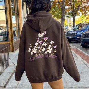 Dark floral print hoodie with white and pink flowers on the back and hood
