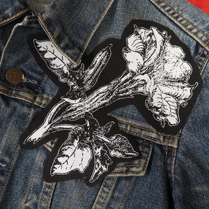 Black embroidered gothic patch with white rose and winged flower illustration