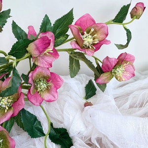 Faux helleborus flower stem with pink blooms and green leaves, artificial decor