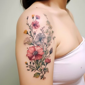 Colorful floral bouquet tattoo design on upper arm and shoulder