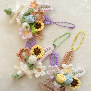Crochet mini bouquet keychain with multicolor flowers, pastel ribbons, and dangling charm