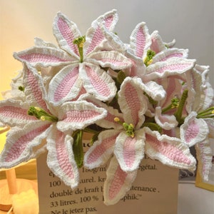 Handmade crochet lily flower bouquet with pink and white blooms and green centers