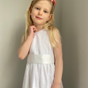 Girls' white linen dress with satin waist sash, sleeveless bodice