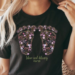 Black nurse T-shirt with floral baby feet graphic and Labor delivery text