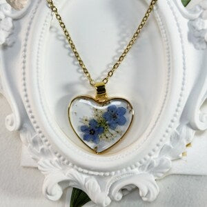 Heart pendant resin necklace with pressed blue forget-me-not flowers and gold chain
