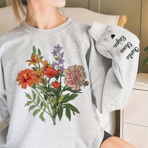 Light gray sweatshirt with colorful birth-flower bouquet graphic on front