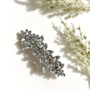 Silver rhinestone flower hair clip with ornate leaf design