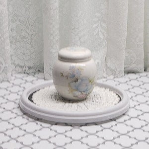 Vintage ceramic ginger jar with white lid and blue floral pattern, round body