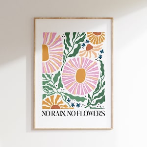 Framed floral poster with colorful botanicals and text 'No rain no flowers'.