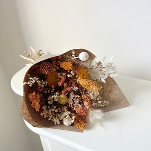 Burnt orange and cream dried flower bundle with brown and tan filler stems