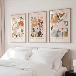 Set of 3 botanical flower market prints in neutral framed artwork, city labels visible