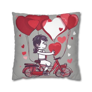 Square pillow case with cartoon girl on red bicycle and red hearts pattern