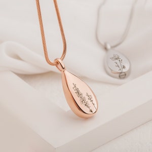Rose-gold teardrop urn pendant necklace with engraved floral birth flower on chain