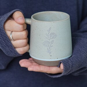 Speckled sage ceramic mug with engraved floral vine design