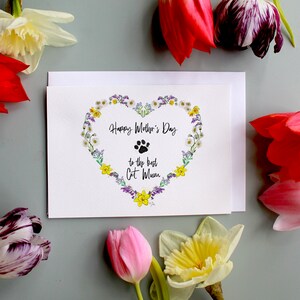 Happy Mother's Day card with floral wreath and cat illustration, message centered on white front