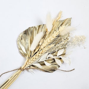 Boho dried flower cake topper with gold palm spear, wheat stems, and small leaf accents