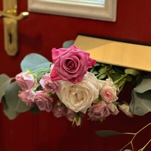 Rose letterbox with pink and cream roses and green foliage