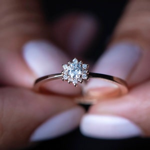 14k gold engagement ring with central cluster diamond and four-prong setting