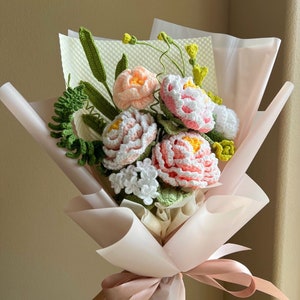 Handmade crochet flower bouquet with pastel pink and white blooms and green leaves