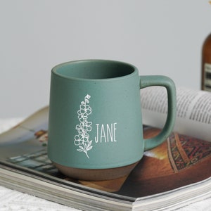 Teal ceramic mug with birth flower line art and name JANE