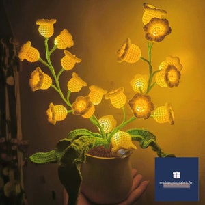 Handmade crochet lily night light in pot, warm yellow glow