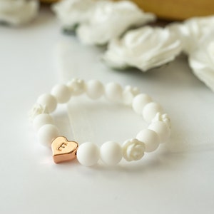 Kids flower girl bracelet with white bead strand and small gold-tone charm