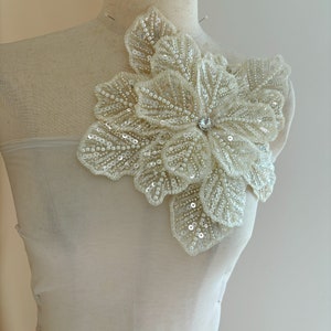 Beige 3D floral appliqué with beaded petals and leaf details