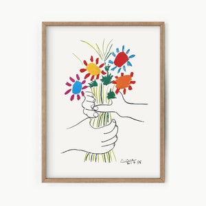 Framed floral wall art with colorful bouquet in a hand holding a vase