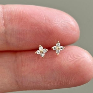 Tiny dainty flower stud earrings with sparkling crystals on small gold-tone posts
