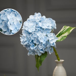 Artificial blue hydrangea stem with clustered blooms and green leaves